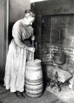 Woman in long skirts using dash churn