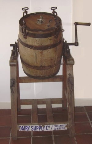 Churn with handle, frame, enamel maker's label