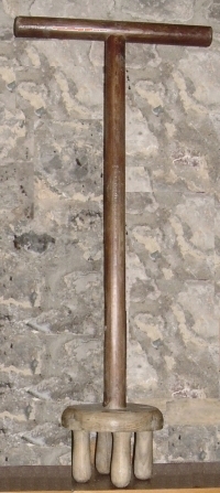 Dolly with four legs long pole and arms or cross-piece handle